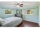 Cozy bedroom with wood floors, two bright windows, and a full dresser at 196 Lark Ave, Brooksville, FL 34601