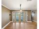 Dining room featuring french doors, hardwood floors, and modern lighting at 196 Lark Ave, Brooksville, FL 34601