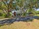 Charming single-story home with mature landscaping, long driveway, and convenient carport at 196 Lark Ave, Brooksville, FL 34601