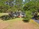 Charming single-story home nestled among mature trees, with a long driveway at 196 Lark Ave, Brooksville, FL 34601