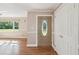 Welcoming foyer with hardwood floors, decorative front door and closet at 196 Lark Ave, Brooksville, FL 34601