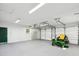 Spacious garage featuring white walls and doors, a window, and a John Deere lawn mower at 196 Lark Ave, Brooksville, FL 34601