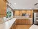 Bright kitchen with white countertops, stainless steel appliances, and mosaic backsplash tiles at 196 Lark Ave, Brooksville, FL 34601