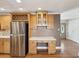 Kitchen featuring stainless steel appliances, wooden cabinets, and a built-in desk area at 196 Lark Ave, Brooksville, FL 34601