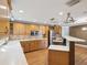 Well-lit kitchen features wood floors, light cabinets, and stainless steel appliances at 196 Lark Ave, Brooksville, FL 34601