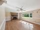 Cozy living room featuring a brick fireplace, built-in shelving, and large window at 196 Lark Ave, Brooksville, FL 34601