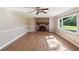 Inviting living room with brick fireplace, built-in shelving, and large window overlooking the yard at 196 Lark Ave, Brooksville, FL 34601