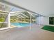 Back view of screened in pool, surrounded by a patio and backyard space, for easy outside enjoyment at 196 Lark Ave, Brooksville, FL 34601
