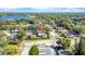 Drone image showcasing the property's location within a neighborhood surrounded by lush greenery and a nearby lake at 2116 Karan Way, Clearwater, FL 33763