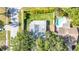 A bird's-eye view of a home with a pool surrounded by lush green landscaping at 2116 Karan Way, Clearwater, FL 33763