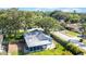 Aerial view of the home showing screened porch, backyard, and mature trees surrounding the property at 2116 Karan Way, Clearwater, FL 33763