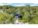 Aerial view of a single-story home with a two-car garage surrounded by mature trees and landscaping at 2116 Karan Way, Clearwater, FL 33763