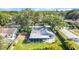 Aerial view of the home highlighting the backyard, screened-in porch, mature trees, and overall neighborhood layout at 2116 Karan Way, Clearwater, FL 33763