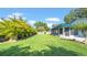 Spacious backyard featuring lush green grass and mature landscaping at 2116 Karan Way, Clearwater, FL 33763