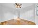 Simple bedroom with ample closet space and natural lighting, complete with wood floors and a ceiling fan at 2116 Karan Way, Clearwater, FL 33763