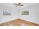 Light-filled bedroom with wood floors and two windows offering great natural light at 2116 Karan Way, Clearwater, FL 33763
