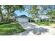 Charming single-story home with lush landscaping and a spacious driveway at 2116 Karan Way, Clearwater, FL 33763