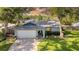 Single story home features a well-manicured lawn with shade trees at 2116 Karan Way, Clearwater, FL 33763