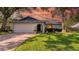 Charming single-story home with a well-manicured lawn, an attached two-car garage, and professional landscaping at 2116 Karan Way, Clearwater, FL 33763