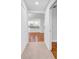 A hallway view reveals the seamless flow into the kitchen, showcasing the home's modern design and open layout at 2116 Karan Way, Clearwater, FL 33763