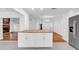 Open concept kitchen with island, stainless appliances, and view to a stone fireplace at 2116 Karan Way, Clearwater, FL 33763