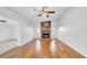 Bright living room featuring a stone fireplace, hardwood floors, and a ceiling fan at 2116 Karan Way, Clearwater, FL 33763