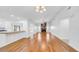 The spacious living area with fireplace features hardwood floors, connecting the kitchen and dining room with ample space at 2116 Karan Way, Clearwater, FL 33763