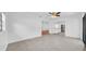Open-concept living space with tile flooring offers seamless flow to the kitchen and outdoor area at 2116 Karan Way, Clearwater, FL 33763