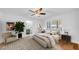Stylishly furnished primary bedroom showcasing natural light, a ceiling fan, and an ensuite bathroom at 2116 Karan Way, Clearwater, FL 33763