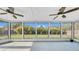 Relaxing screened-in patio with ceiling fans and views of the lush backyard at 2116 Karan Way, Clearwater, FL 33763