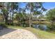 Backyard view of a peaceful pond from a paver patio at 2235 Lytham Ct, Spring Hill, FL 34606