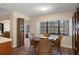 Dining area featuring hardwood floors, a round table and a gorgeous lake view at 2235 Lytham Ct, Spring Hill, FL 34606