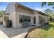 Neutral-colored exterior with a paver patio and a gray bench at 2235 Lytham Ct, Spring Hill, FL 34606