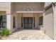 Inviting front porch with double doors, neutral colored stucco and a lattice wall above at 2235 Lytham Ct, Spring Hill, FL 34606