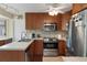 Updated kitchen featuring track lighting, stainless appliances, and ample counter space at 2235 Lytham Ct, Spring Hill, FL 34606