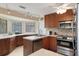Kitchen with stylish track lighting, stainless appliances, ample countertops and tile backsplash at 2235 Lytham Ct, Spring Hill, FL 34606
