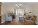 Open living room with vaulted ceilings, neutral colors, hardwood floors and lots of natural light at 2235 Lytham Ct, Spring Hill, FL 34606