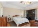 This main bedroom features classic furnishings, a ceiling fan, and a built-in desk area at 2235 Lytham Ct, Spring Hill, FL 34606
