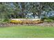 Stone sign for the Timber Pines community, surrounded by flowers at 2235 Lytham Ct, Spring Hill, FL 34606