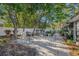 A backyard patio area underneath shade trees with a stone base and outdoor furniture at 2254 Coachman Rd, Spring Hill, FL 34608