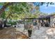 An outdoor patio area under shade trees with outdoor furniture at 2254 Coachman Rd, Spring Hill, FL 34608