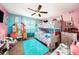 Playful bedroom with unique bunk beds, pink and blue walls, and a large window for plenty of natural light at 2254 Coachman Rd, Spring Hill, FL 34608