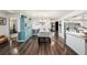 Open-concept dining area featuring wood floors, a modern chandelier, and natural light at 2254 Coachman Rd, Spring Hill, FL 34608