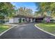 Charming single-story home featuring a well-maintained front yard and a long driveway leading to an attached garage at 2254 Coachman Rd, Spring Hill, FL 34608