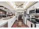 Bright kitchen featuring white cabinets, modern appliances, and a view of the open-concept living space at 2254 Coachman Rd, Spring Hill, FL 34608
