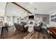 Comfortable living room featuring a fireplace, wood flooring, comfortable seating, and natural light at 2254 Coachman Rd, Spring Hill, FL 34608