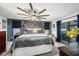 Comfortable main bedroom featuring a large bed, natural light, and stylish decor with accents of blues at 2254 Coachman Rd, Spring Hill, FL 34608