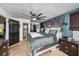 Cozy main bedroom features a decorative accent wall, soft carpet, and a ceiling fan for added comfort at 2254 Coachman Rd, Spring Hill, FL 34608