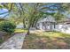 A large backyard shed with double doors and a covered porch at 2254 Coachman Rd, Spring Hill, FL 34608