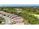Aerial view of the home showing lush greenery, a pond and ocean views at 2325 Pleasant Hill Ln, Holiday, FL 34691